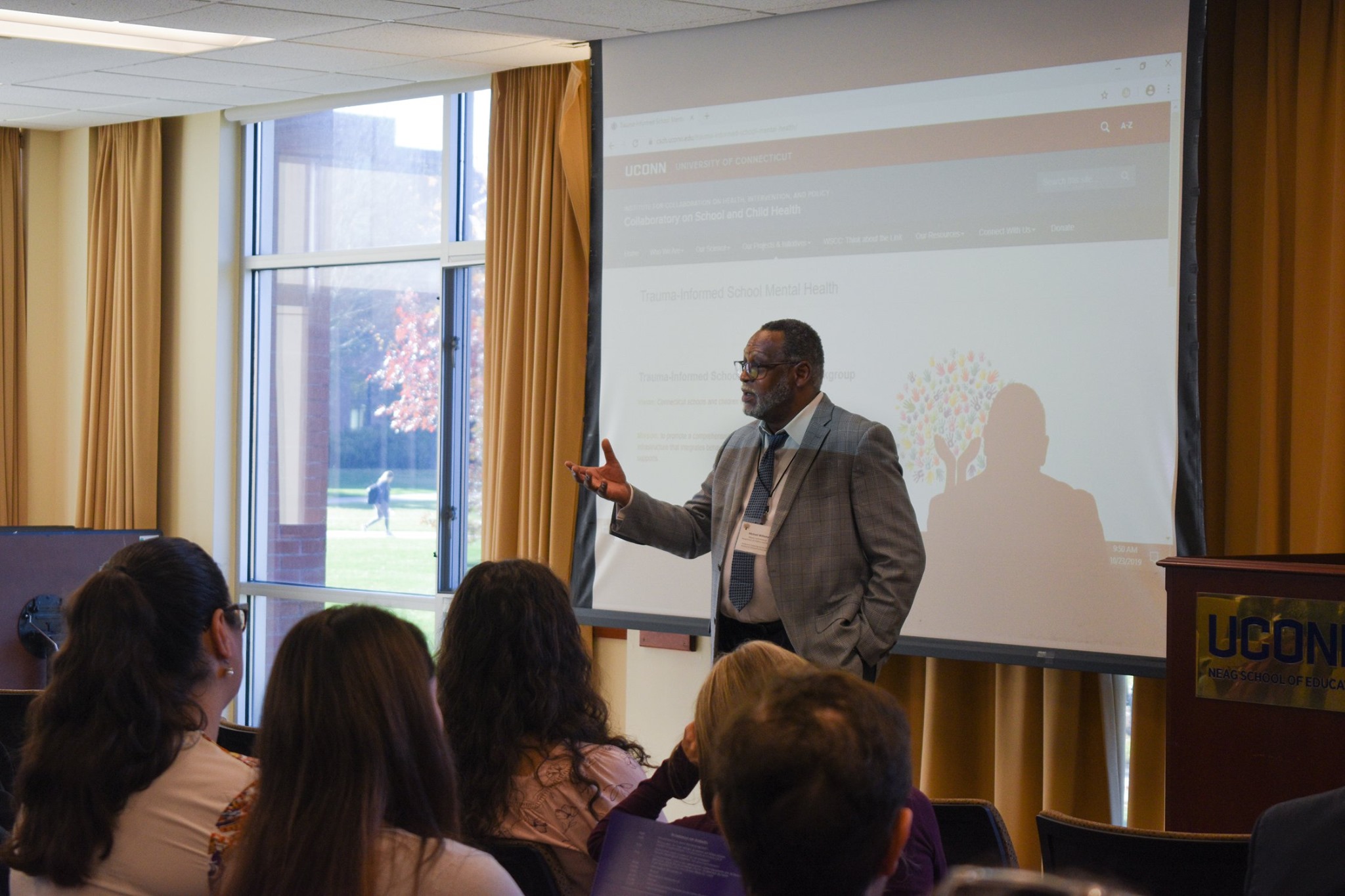 DCF Deputy Commissioner Michael Williams presents to the attendees of the second Trauma-Informed School Mental Health Symposium